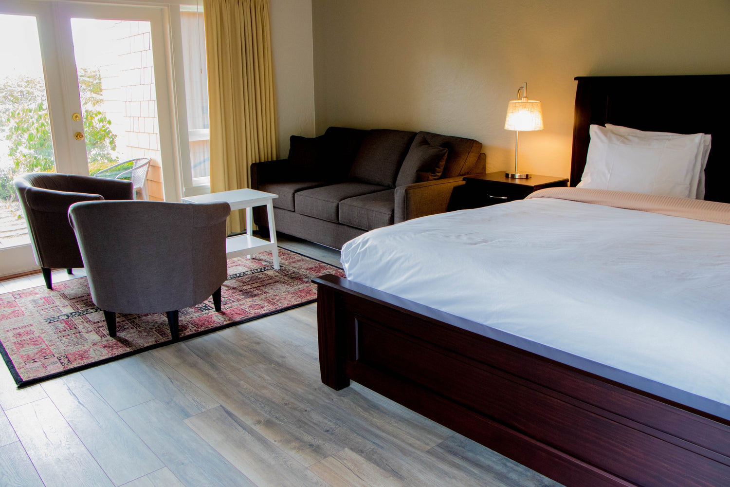 West Coast Suite with oceanfront view, cozy wood-burning fireplace, and elegant interiors